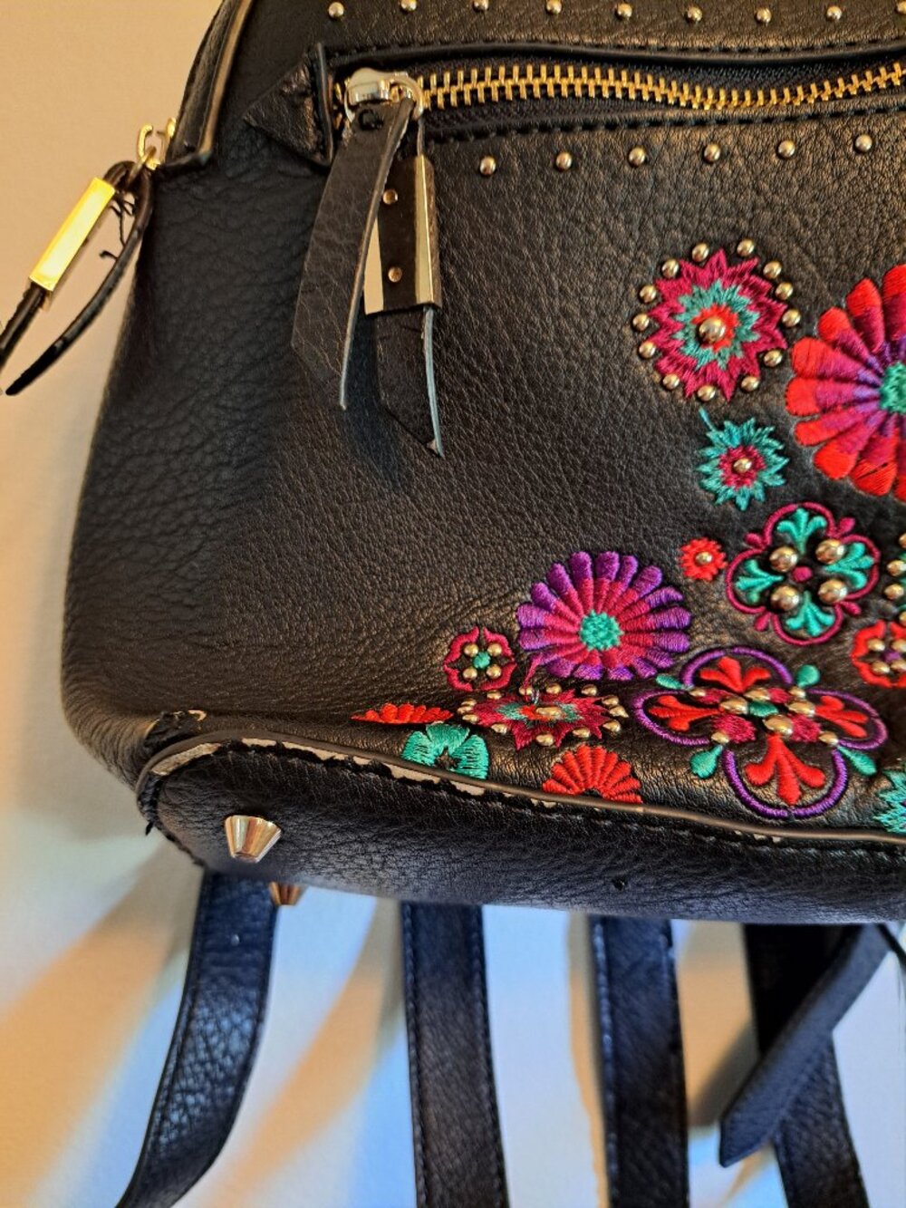 Black Steve Madden embroidered floral backpack with gold hardware. - Picture 2 of 13